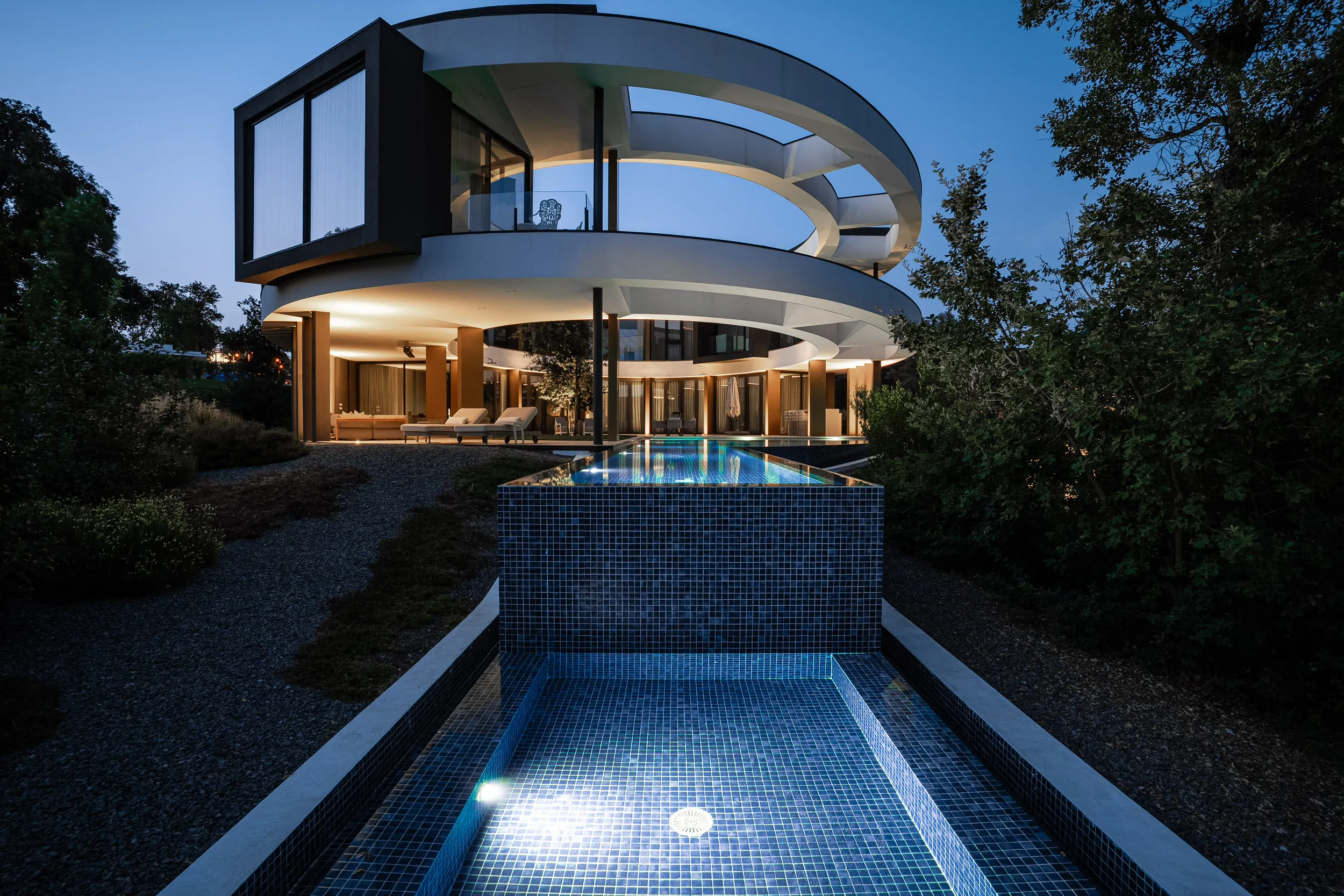 De villa in Girona in de schemering, met verlicht zwembad